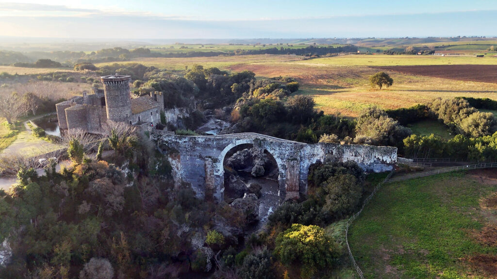 Historic arch bridge Ponte dell'Abbadia and Castello in Vulci